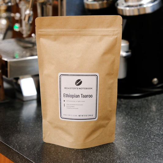 Kraft paper coffee bag with a label on a counter in a coffee shop.